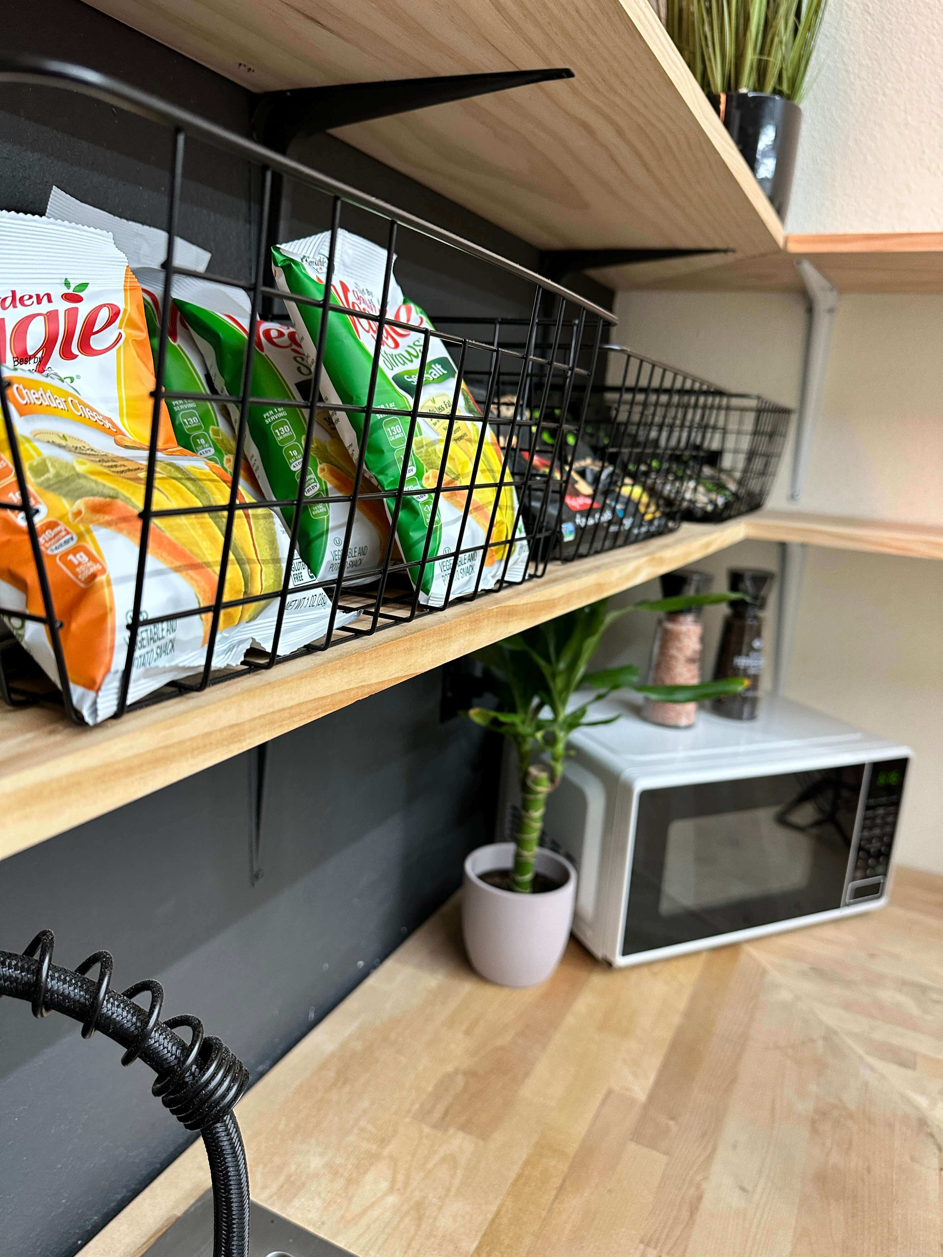a photo of the kitchen: fridge, coffee maker, snacks